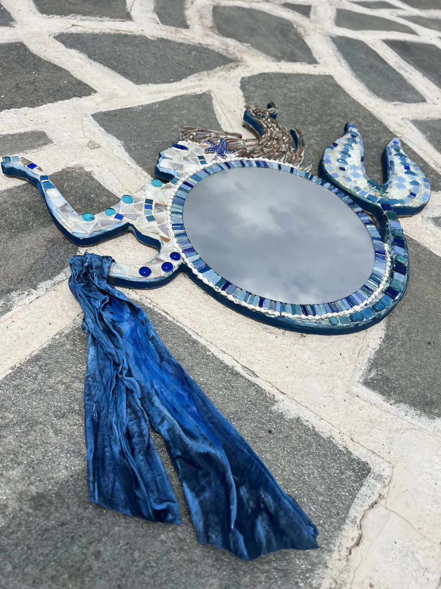 Nerida from above, the blue tassel spread across the paving
