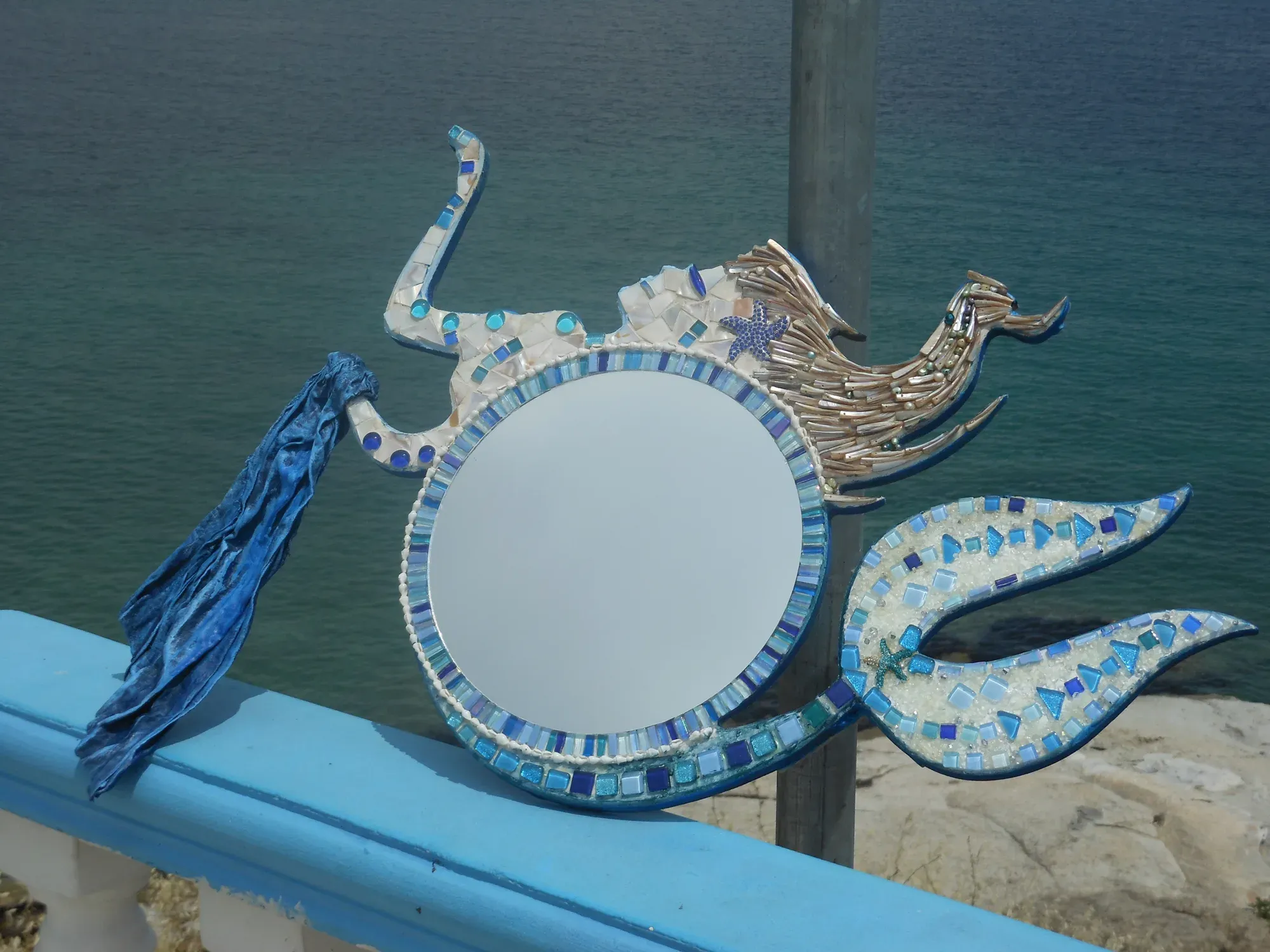 Nerida from above, the blue tassel spread across the paving