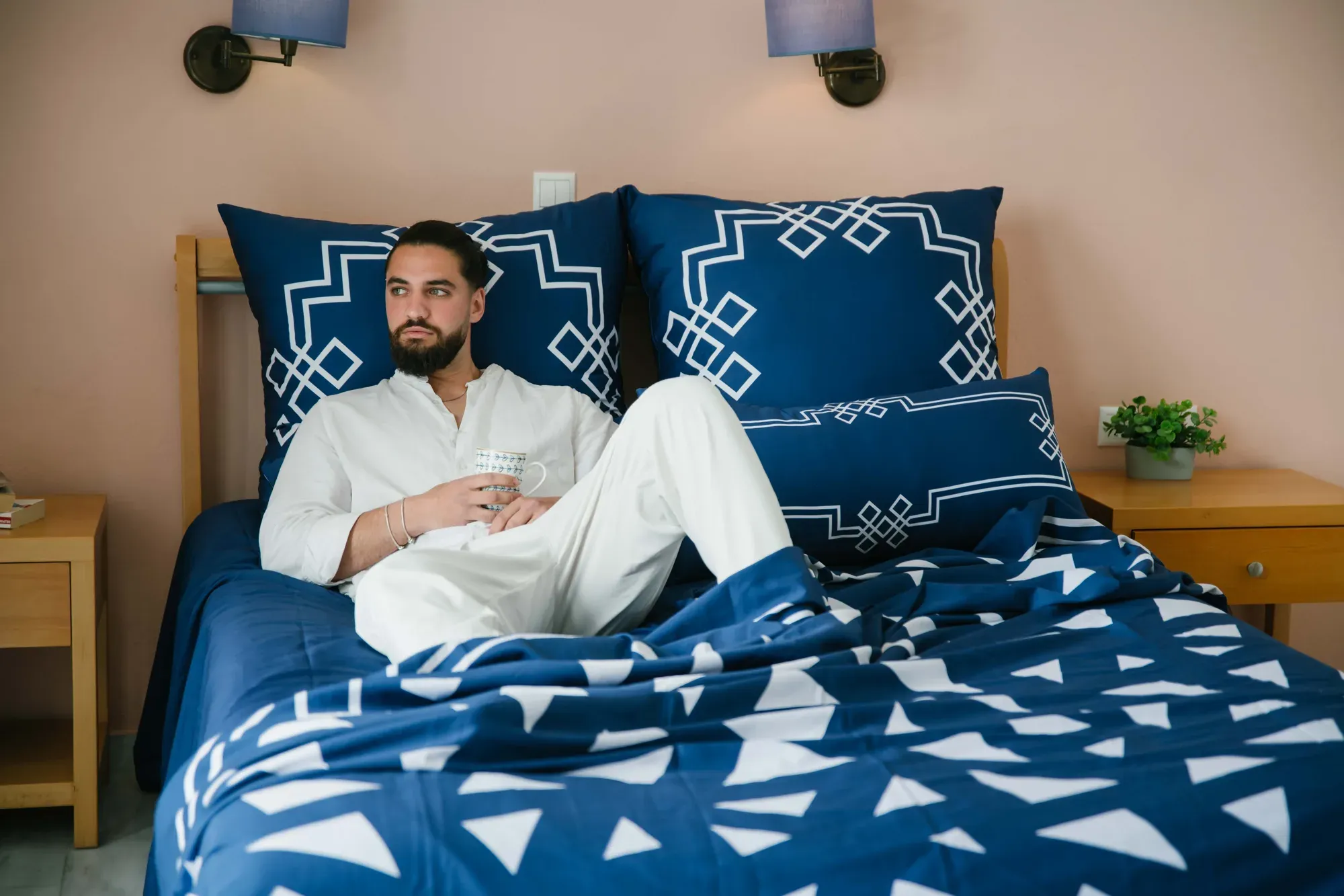 A man lying on a bed made in Mythos Tides