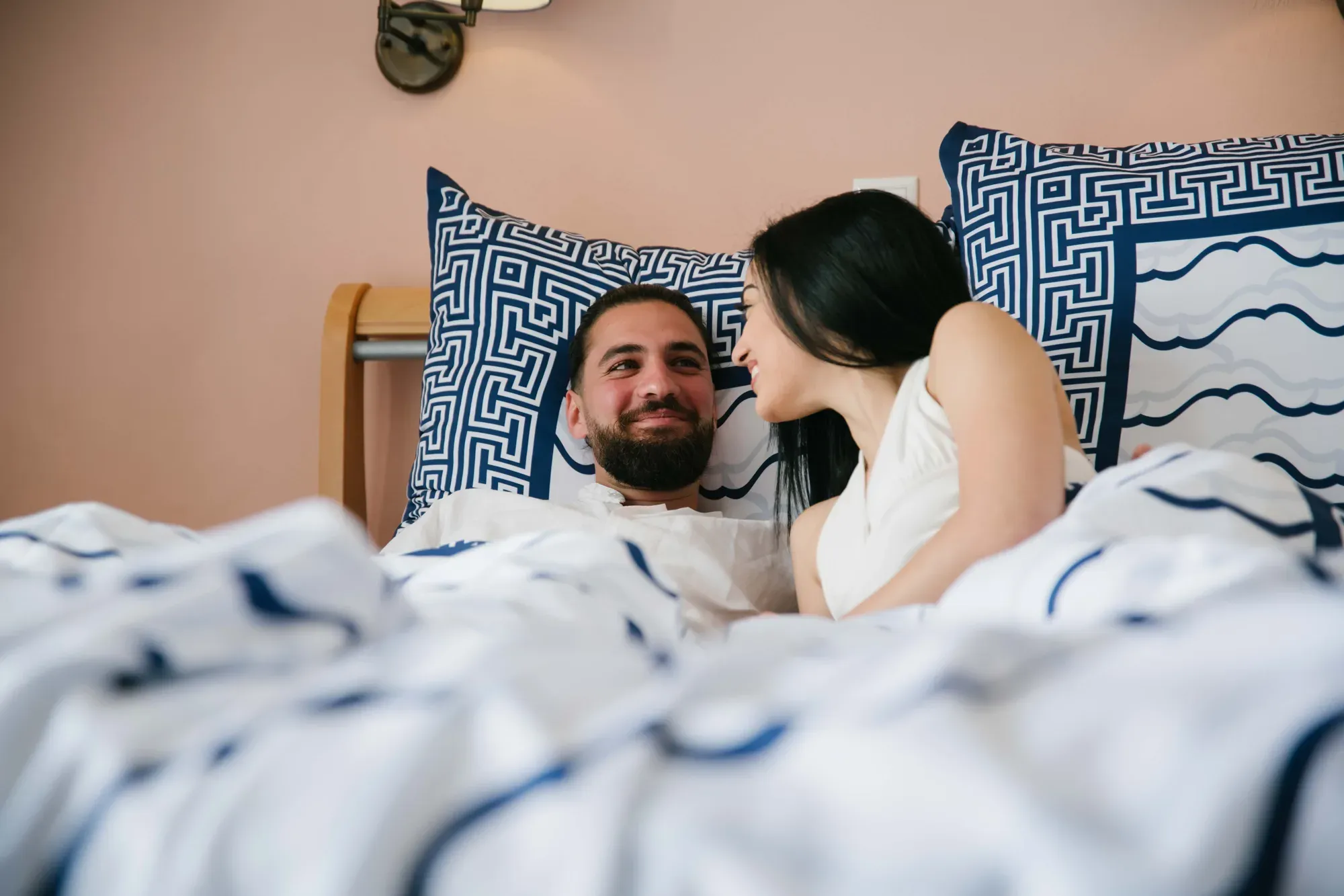 A couple laughing under a Cycladic Serenity duvet