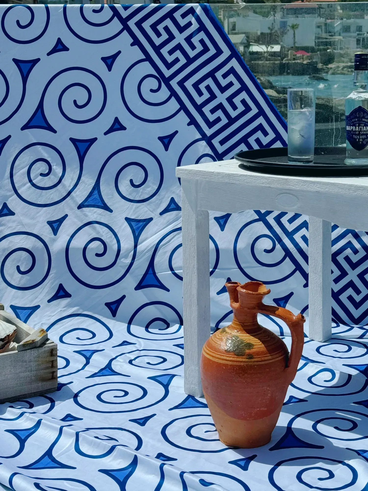Aegean Whispers duvet on a terrace in Crete, a clay jar and prickly pear against the sea